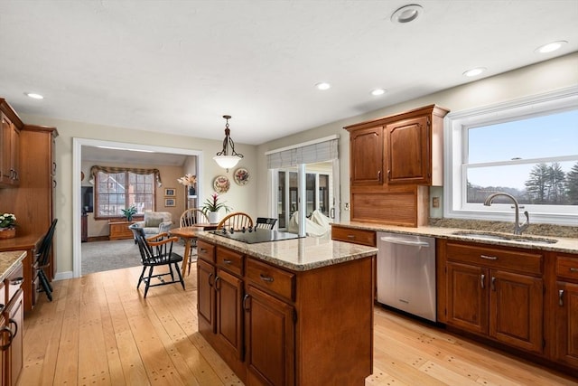 14 Frost Ln, Sudbury, MA 01776 - kitchen with stainless steel dishwasher, a center island, hanging light fixtures, light wood-style flooring, and light stone countertops