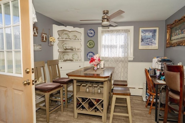 dining space featuring ceiling fan and wood finished floors