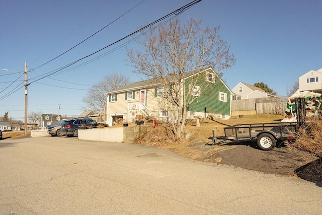 view of front of house featuring fence and a residential view