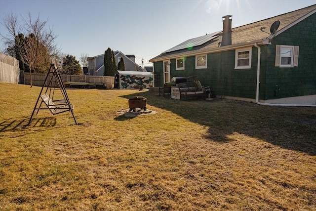 view of yard featuring an outdoor fire pit and a fenced backyard