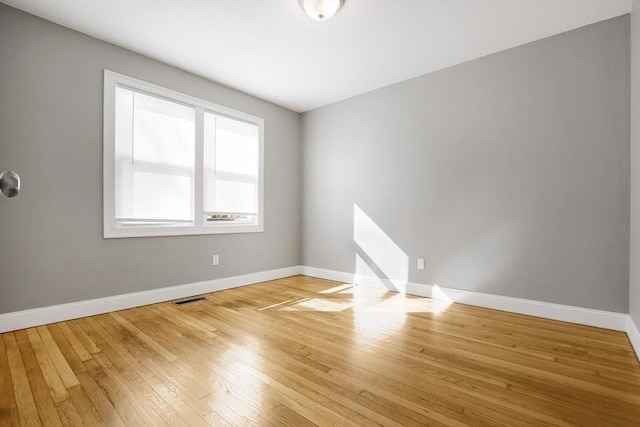 unfurnished room with light hardwood / wood-style flooring