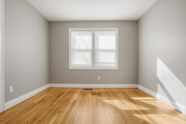 spare room with hardwood / wood-style floors