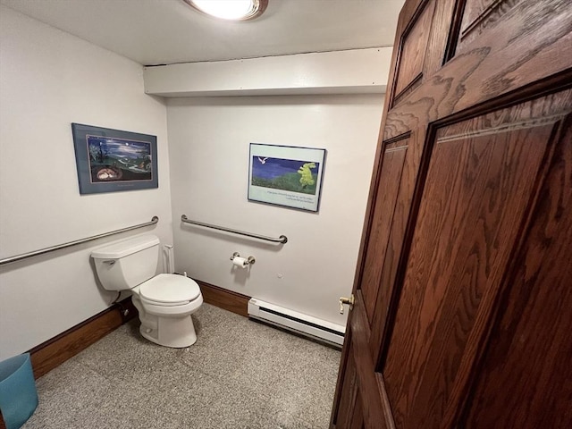 bathroom with baseboard heating, baseboards, and toilet
