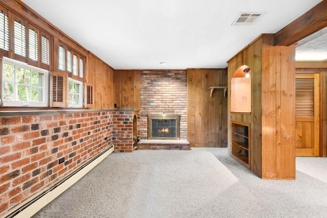 27 Woodland St, Natick, MA 01760 - unfurnished living room with a baseboard radiator, carpet floors, a fireplace, wooden walls, and brick wall