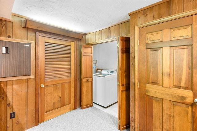 27 Woodland St, Natick, MA 01760 - corridor with washer / clothes dryer, wooden walls, light carpet, and a textured ceiling