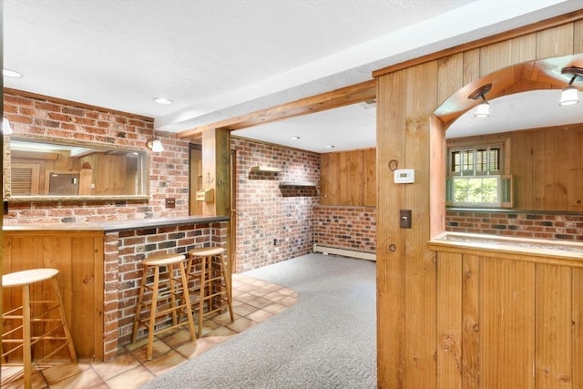 27 Woodland St, Natick, MA 01760 - indoor dry bar with brick wall, a baseboard heating unit, carpet, and wooden walls