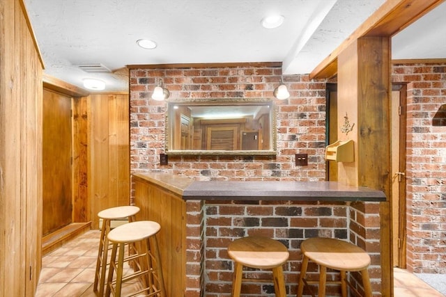 27 Woodland St, Natick, MA 01760 - bar area featuring tile patterned floors, wooden walls, and a textured ceiling