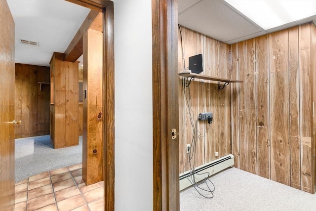 27 Woodland St, Natick, MA 01760 - detailed view of baseboard heating, wood walls, and carpet flooring
