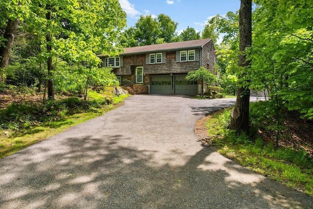 27 Woodland St, Natick, MA 01760 - bi-level home with asphalt driveway and a garage