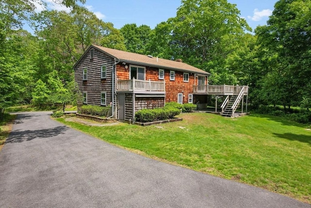 27 Woodland St, Natick, MA 01760 - view of front of property featuring stairs, a wooden deck, and a front lawn