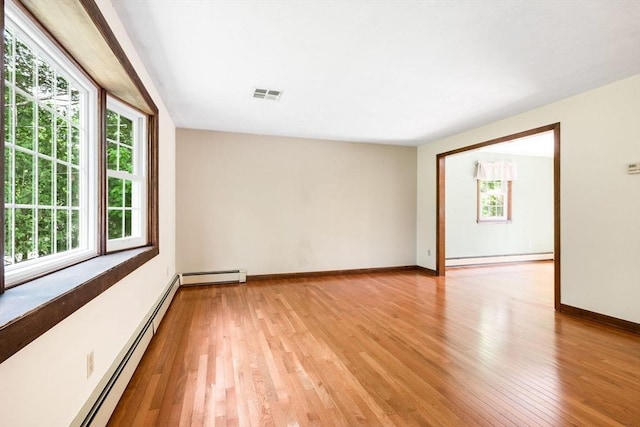 27 Woodland St, Natick, MA 01760 - unfurnished room with light wood-type flooring, a baseboard heating unit, and baseboards