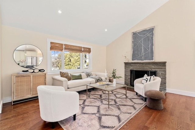 living room featuring lofted ceiling, wood finished floors, recessed lighting, a fireplace, and baseboards