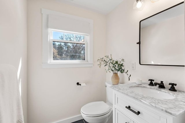 bathroom with toilet and vanity