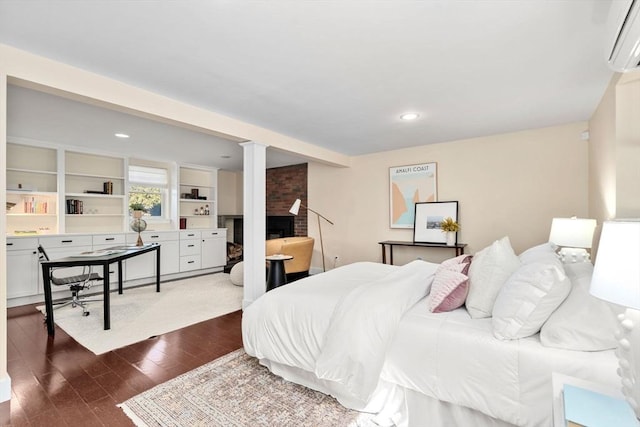 bedroom with recessed lighting, decorative columns, dark wood-style floors, and a wall unit AC