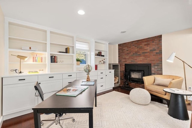 office space with built in features, recessed lighting, and dark wood-style flooring