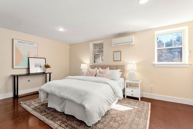 bedroom with recessed lighting, wood finished floors, baseboards, and a wall mounted AC