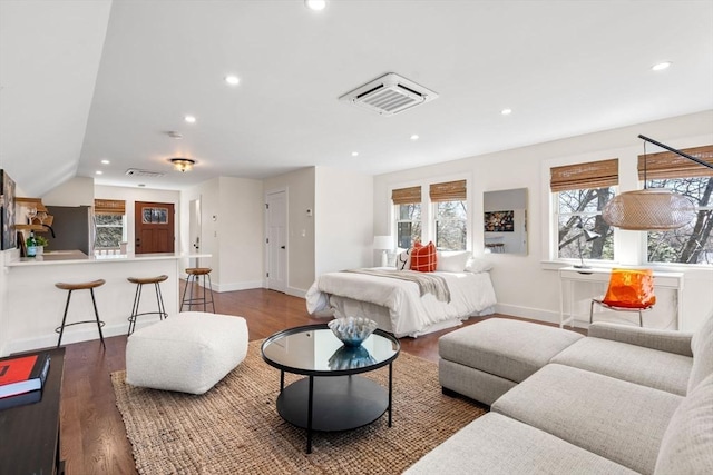 bedroom featuring recessed lighting, baseboards, dark wood-style flooring, and freestanding refrigerator