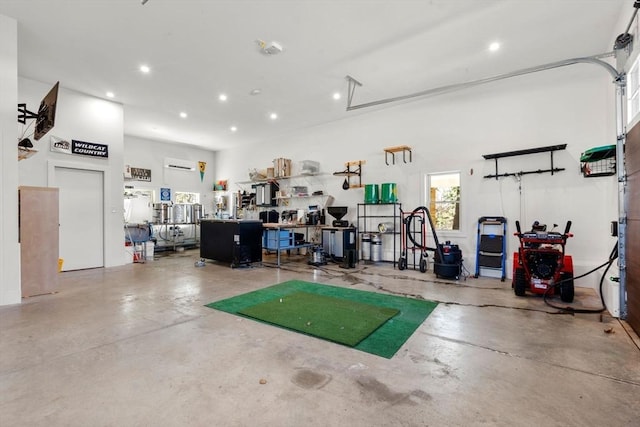 garage with recessed lighting and a wall mounted AC