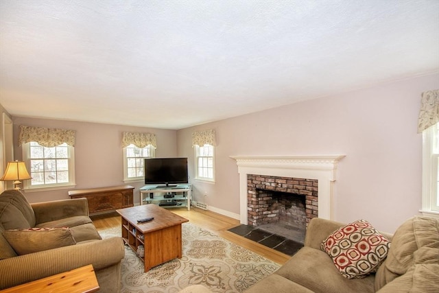 living room featuring a fireplace, wood finished floors, and baseboards