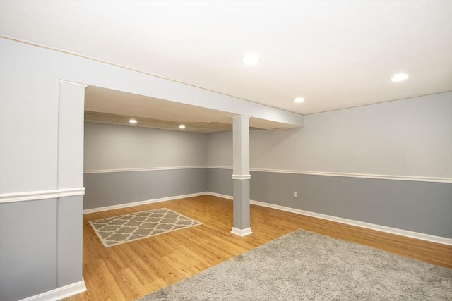 finished below grade area with recessed lighting, wood finished floors, and baseboards