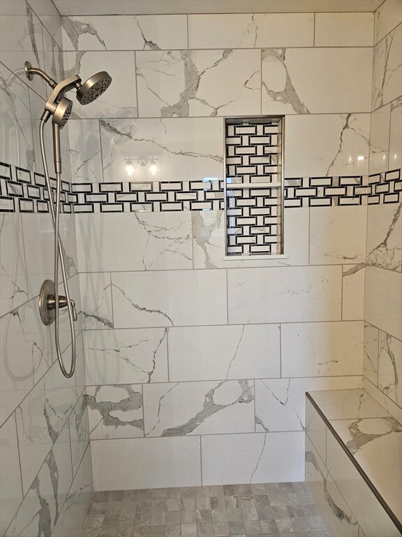 bathroom with a tile shower