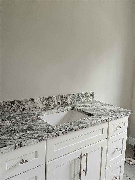 bathroom with vanity, toilet, and a tile shower