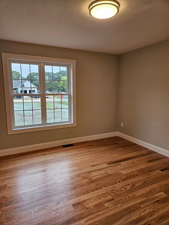 spare room with light hardwood / wood-style flooring