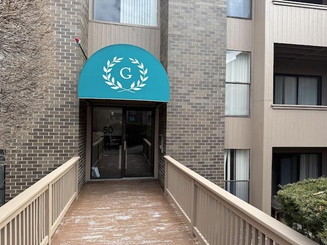 view of exterior entry with brick siding