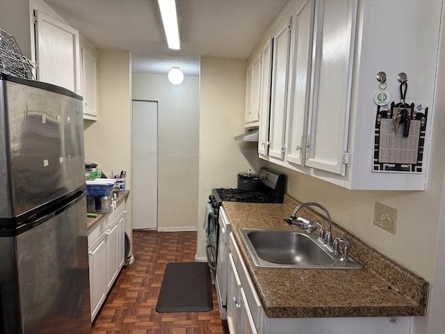 kitchen featuring white cabinets, appliances with stainless steel finishes, and a sink