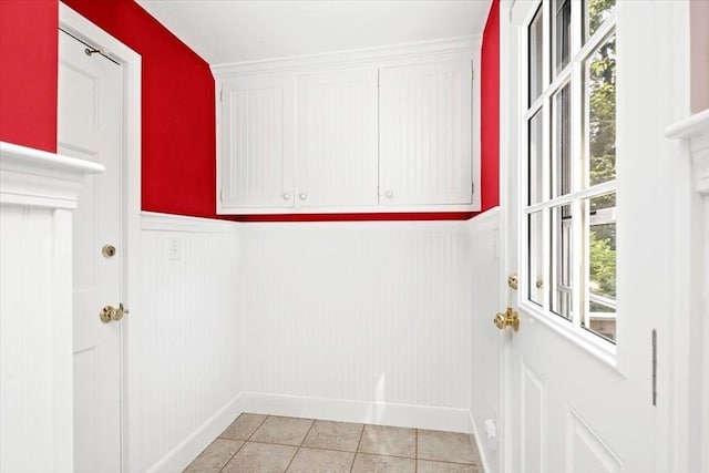 laundry area featuring light tile patterned flooring and plenty of natural light