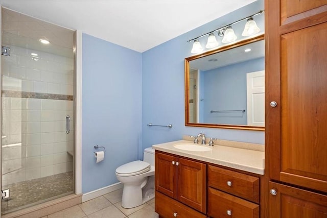 bathroom with vanity, a shower with shower door, tile patterned floors, and toilet