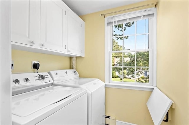 clothes washing area featuring independent washer and dryer, cabinets, and a baseboard radiator