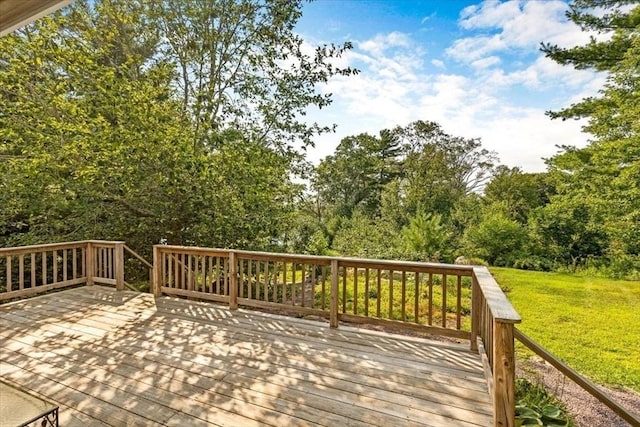 wooden terrace featuring a lawn