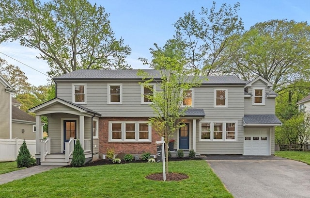 17 Melrose Ave, Needham, MA 02492 - view of front of house with asphalt driveway, brick siding, and an attached garage