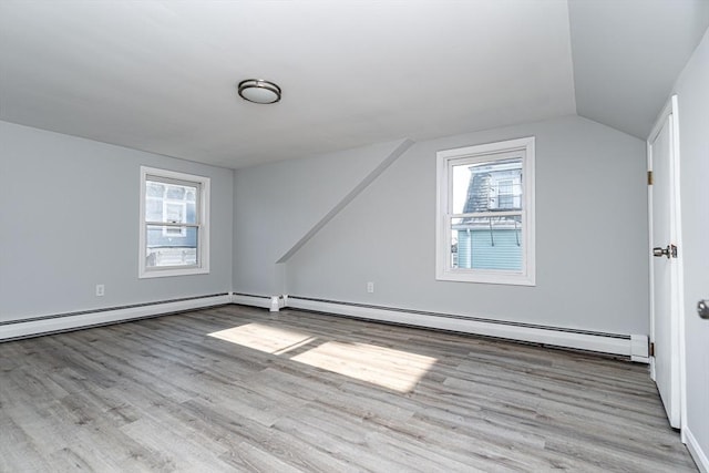 bonus room featuring vaulted ceiling, a healthy amount of sunlight, and light wood-type flooring