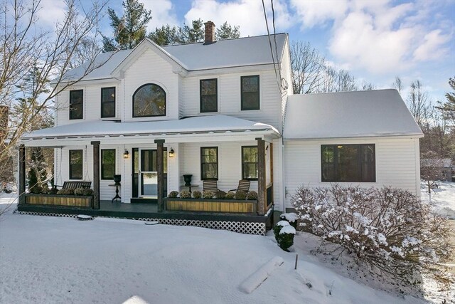 view of front of property featuring a porch and a chimney