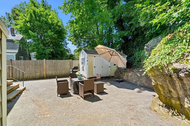 12 Shore Ave, Salem, MA 01970 - fenced backyard featuring a patio, a storage shed, and outdoor dining space