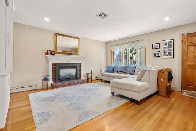 12 Shore Ave, Salem, MA 01970 - living area with a baseboard heating unit, light wood-style floors, a fireplace, and recessed lighting