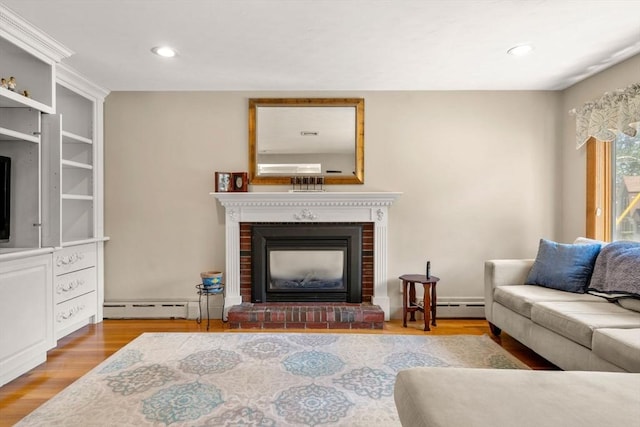 12 Shore Ave, Salem, MA 01970 - living area featuring a brick fireplace, a baseboard radiator, wood finished floors, and recessed lighting