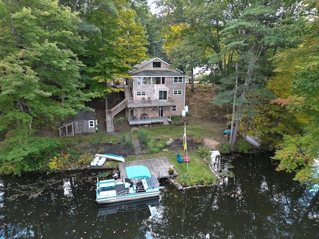 rear view of house with a deck with water view