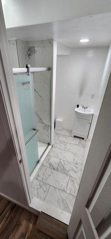 8 Suffield St, Worcester, MA 01610 - full bathroom featuring a marble finish shower, marble look tile flooring, baseboards, and vanity
