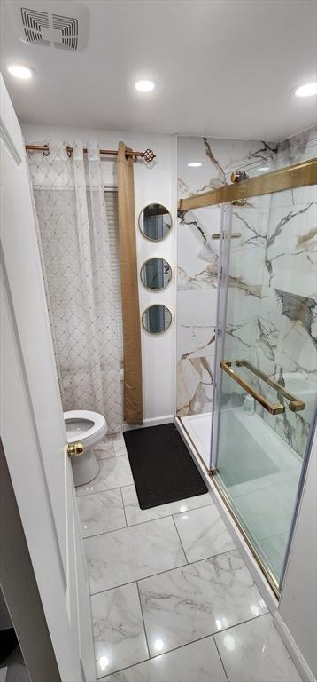 8 Suffield St, Worcester, MA 01610 - bathroom with a marble finish shower, toilet, marble look tiles, and recessed lighting