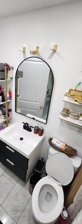 8 Suffield St, Worcester, MA 01610 - bathroom with marble finish floors, vanity, and toilet