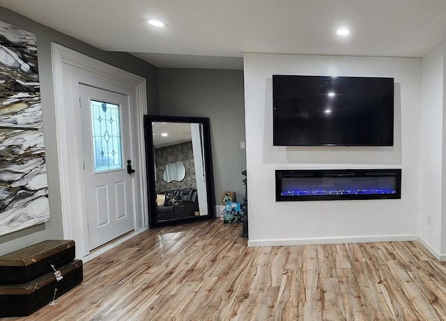 8 Suffield St, Worcester, MA 01610 - foyer entrance featuring wood finished floors, a glass covered fireplace, recessed lighting, and baseboards