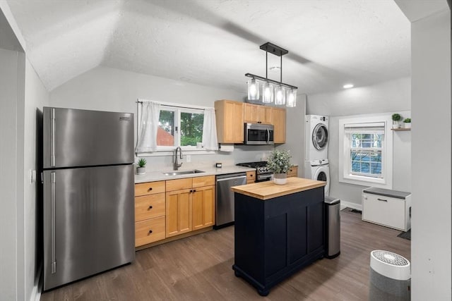 7 Summit Ave, Sharon, MA 02067 - kitchen with appliances with stainless steel finishes, estacked washer and dryer, dark wood-type flooring, butcher block counters, and lofted ceiling