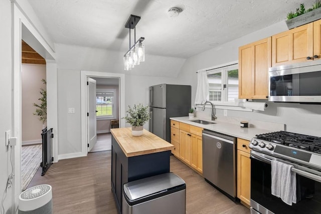 7 Summit Ave, Sharon, MA 02067 - kitchen with stainless steel appliances, light brown cabinets, butcher block countertops, wood finished floors, and a textured ceiling