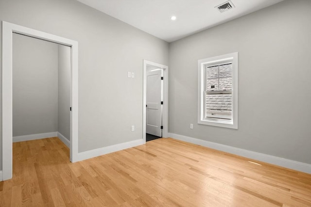 unfurnished bedroom featuring a closet and light wood-type flooring