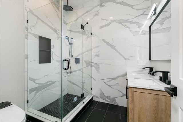 bathroom featuring an enclosed shower, vanity, tile patterned floors, and toilet