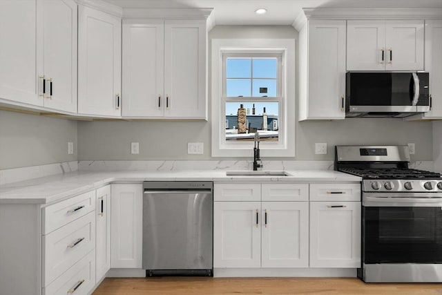 kitchen featuring white cabinetry and appliances with stainless steel finishes