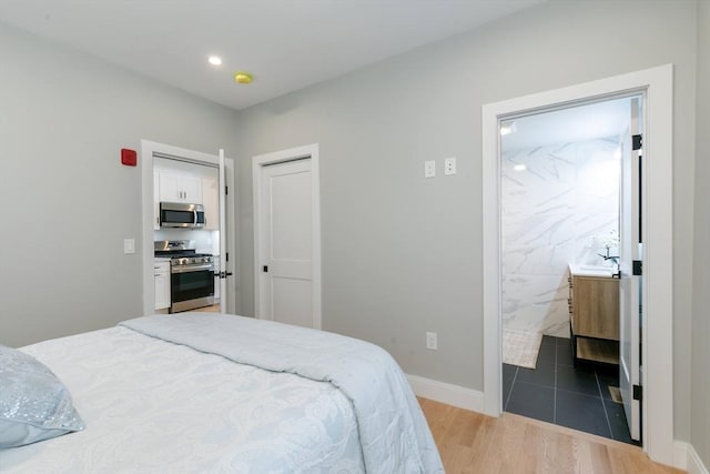 bedroom featuring hardwood / wood-style floors and tile walls